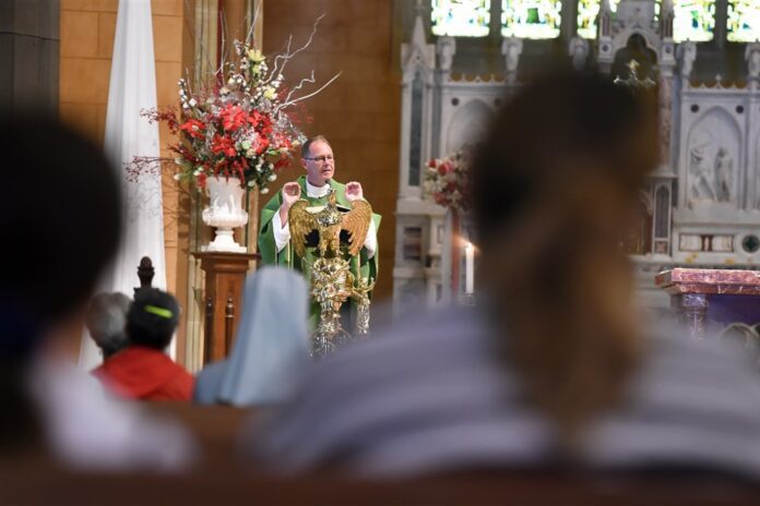 Kunigas Jimas McKay per Mišias už katalikų kardinolo George'o Pello sielą Šv. Patriko katedroje Balarato mieste, Vikijos valstijoje, Australijoje / EPA nuotr.
