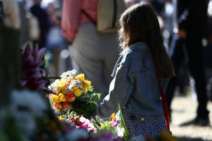 Mergaitė su laidotuvių gėlėmis Edinburge, Škotijoje / EPA nuotr.