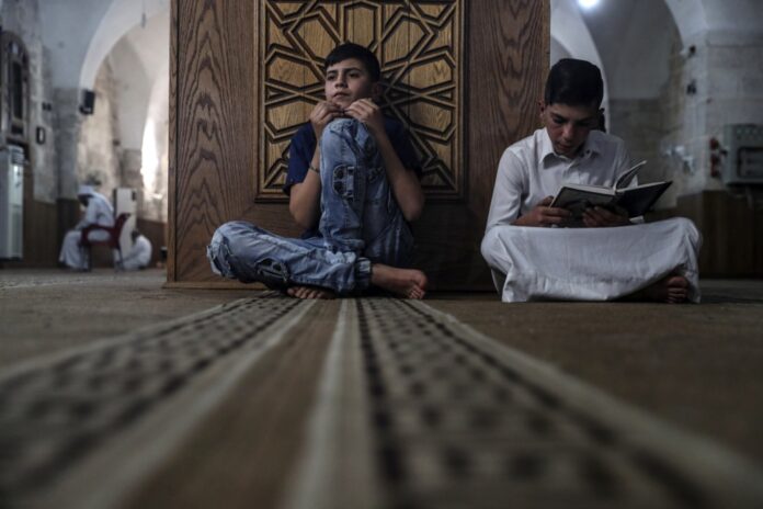 Jauni musulmonai skaito Koraną / EPA nuotr.
